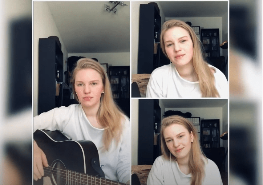 Frau im Bild singt mit Gitarre